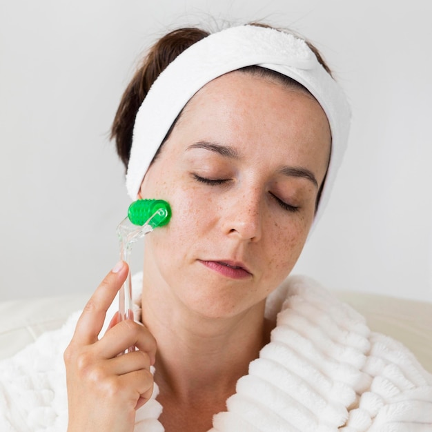 Woman using her headband and massaging the face close-up