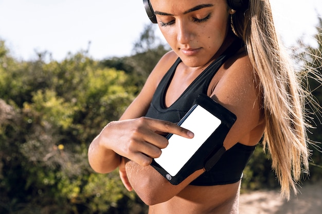 Woman using her phone armband mock-up