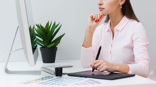 Woman using her tablet at desk