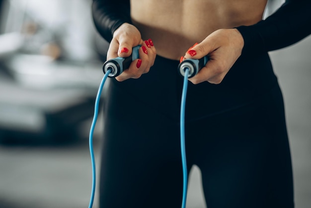 Free photo woman using jumping rope at the gym