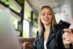 Free photo woman using laptop computer to pay the bill online