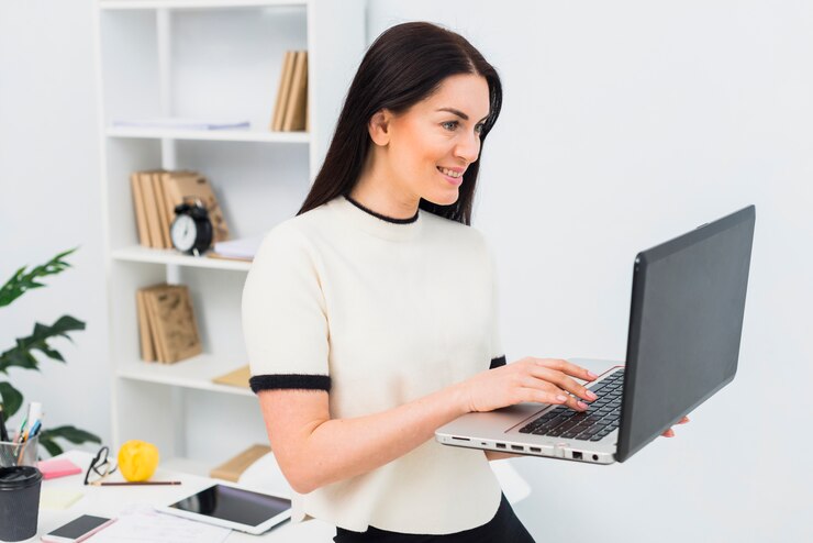 Free Photo woman using laptop in office 