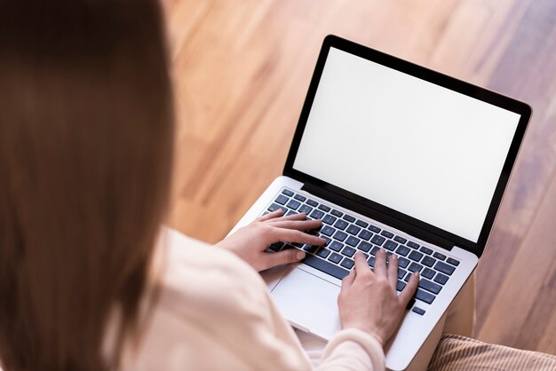 Woman using laptop with blank screen