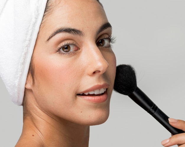 Woman using a make-up brush