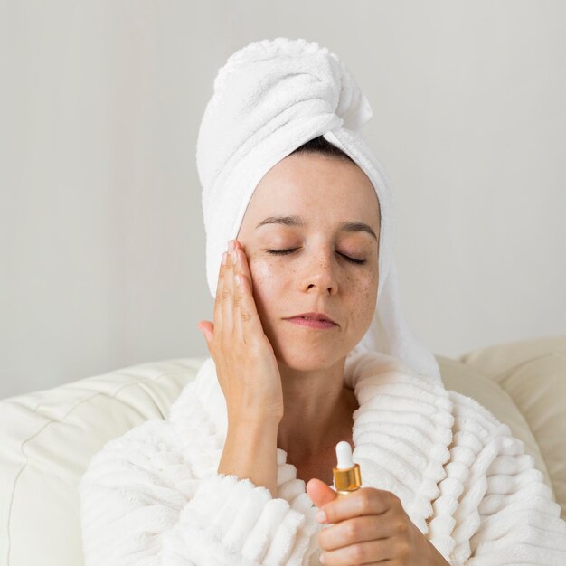 Woman using moisturizer for her skin