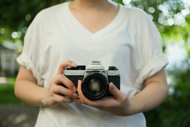 Woman using old vintage camera