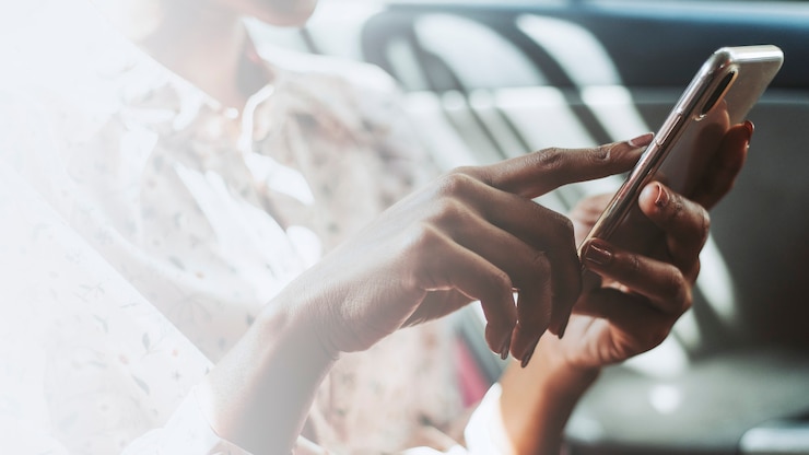 Free Photo woman using a phone in a car
