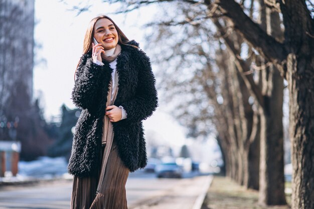 Woman using phone outside sthe street