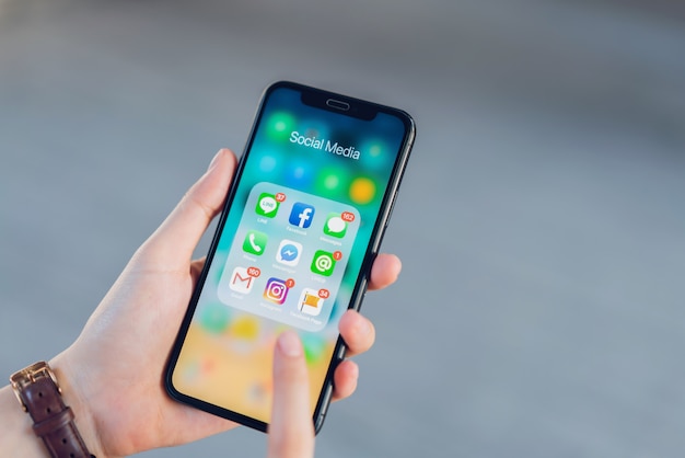 Woman using phone of show display app social media screen.