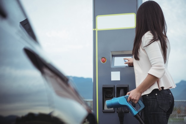 Free photo woman using plug-in electric machine