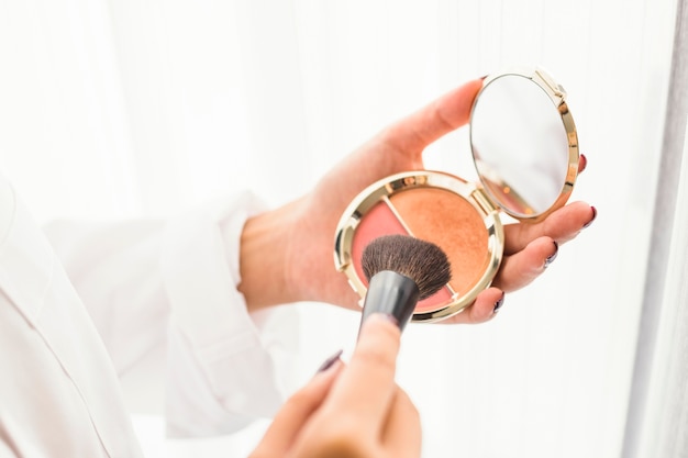 Woman using powder brush