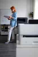 Free photo woman using printer at the office