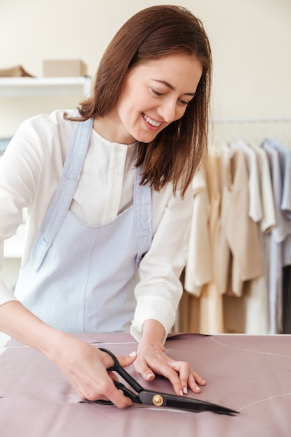 Woman using scissors to cut fabric