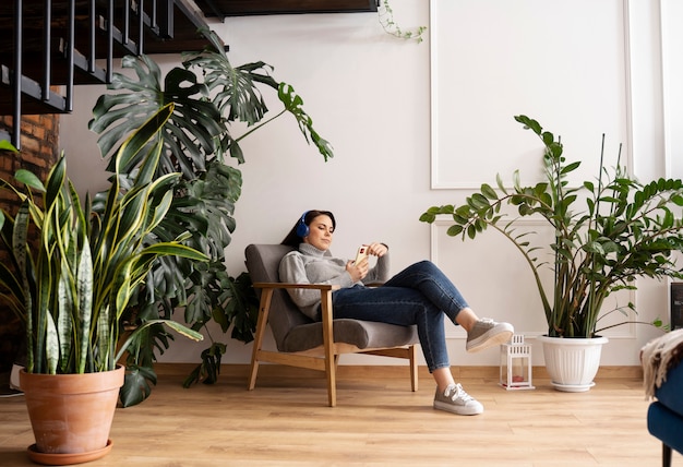 Free photo woman using smartphone as a habit