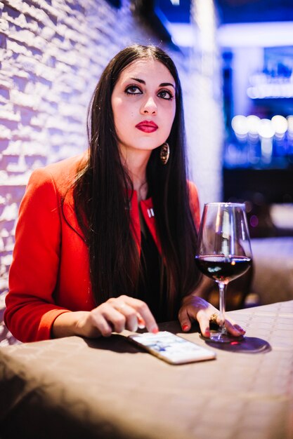 Woman using smartphone in restaurant