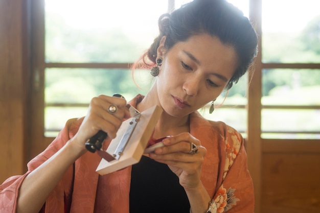 Woman using a stamp on origami paper