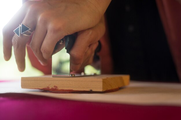 woman using a stamp on origami paper
