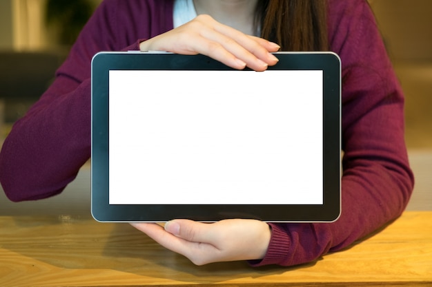 Woman using tablet in coffee shop