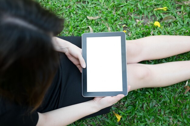 Woman using tablet in garden