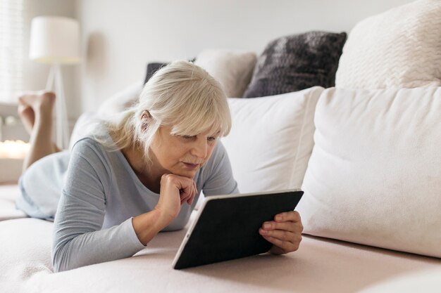 Woman using tablet and thinking