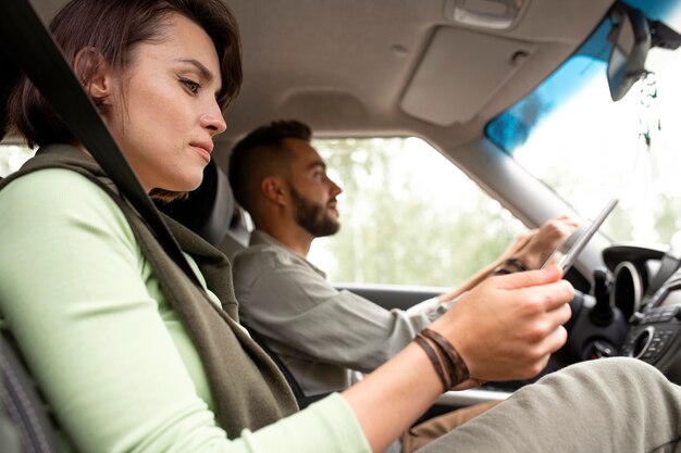 彼氏が運転中にタブレットを使用している女性