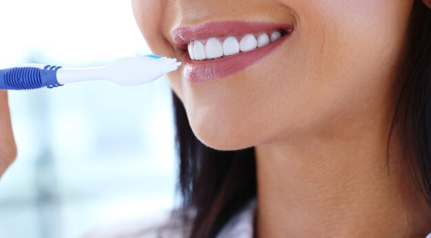 Woman using toothbrush