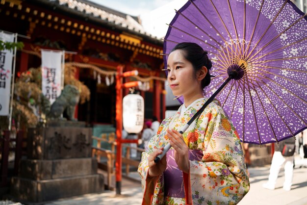 Woman using wagasa umbrella side view