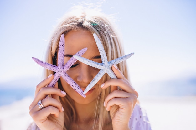 Woman on a vacation holding a starfish