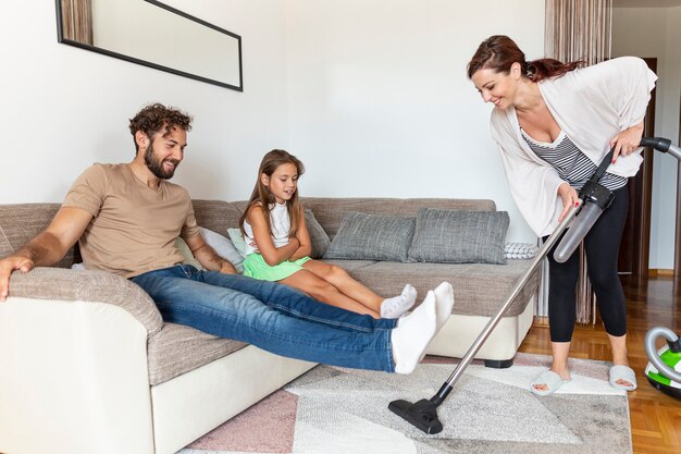 Woman vacuuming the carpet