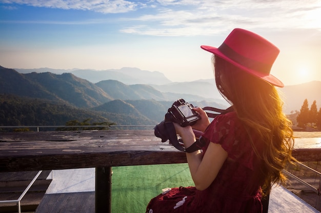 Foto gratuita donna che guarda le foto sulla fotocamera