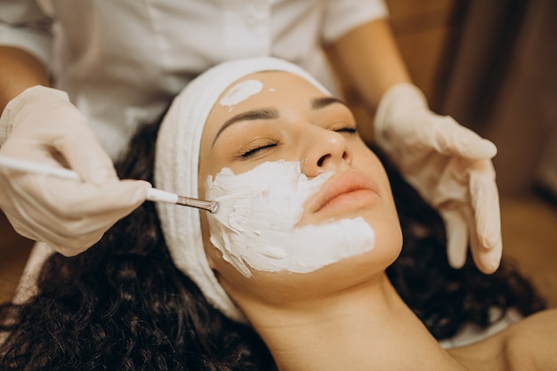 Woman visiting cosmetologist and making rejuvenation procedures