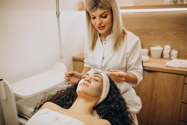 Woman visiting cosmetologist and making rejuvenation procedures