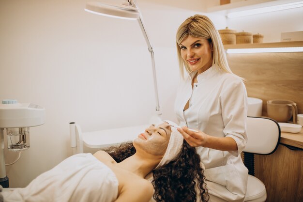 Woman visiting cosmetologist and making rejuvenation procedures