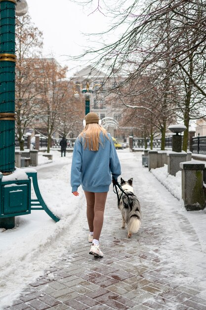 Woman walking accompanied by her pet