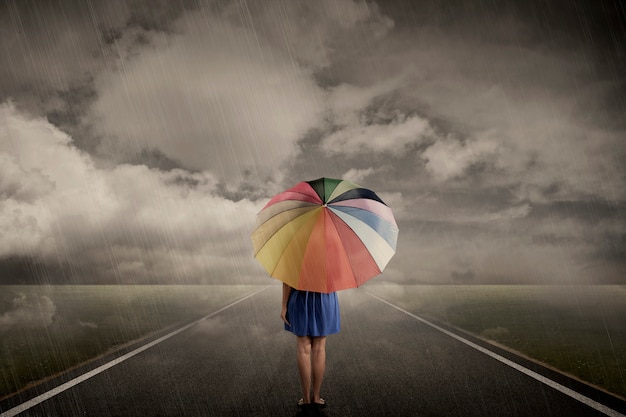 girl walking alone in rain