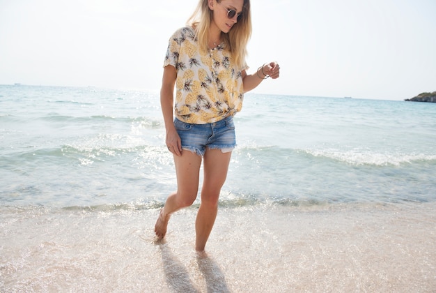 Free photo woman walking on the beach summer vacation