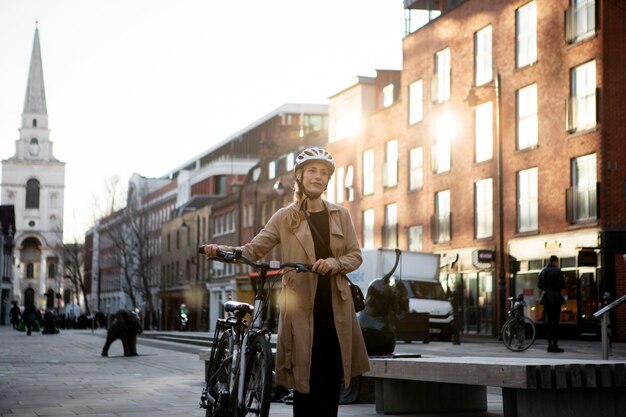 Woman walking by her bike in the city