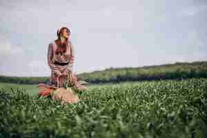 Free photo woman walking in a field with lupinuses