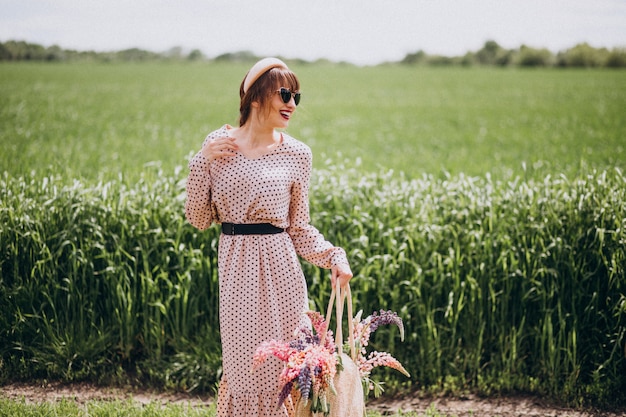 Woman walking in a field with lupinuses