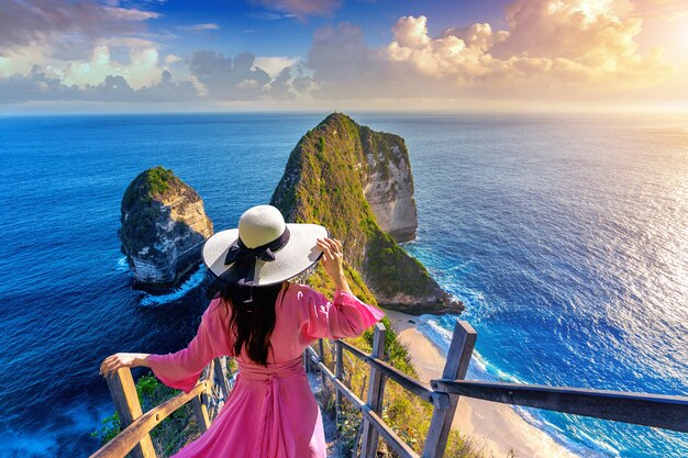 Woman walking at Kelingking Beach in Nusa penida island, Bali, Indonesia