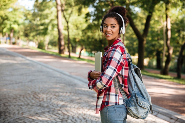 Free Photo woman walking outdoors in park.