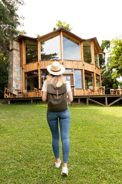 Woman walking towards a house from behind