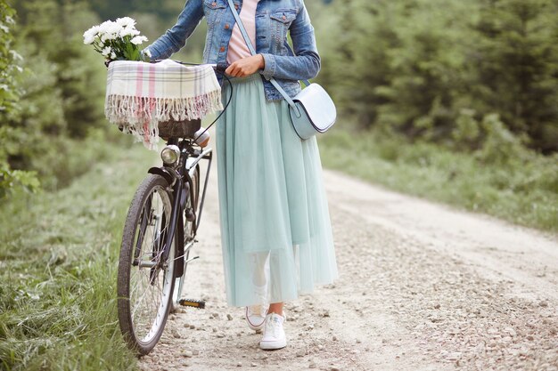 森の中を自転車で歩く女性