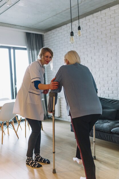 Woman walking with nurse in retirement home