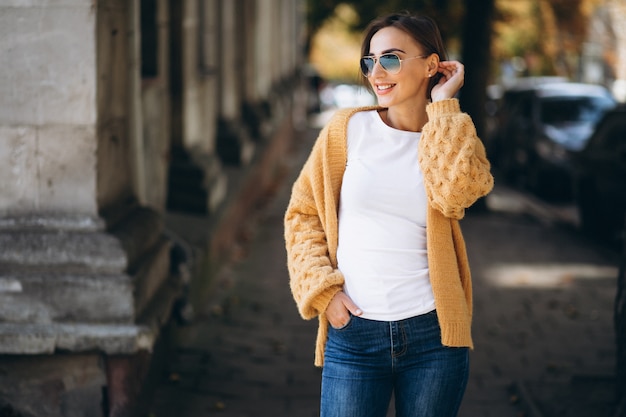 Woman in warm cloths outside in autumn park