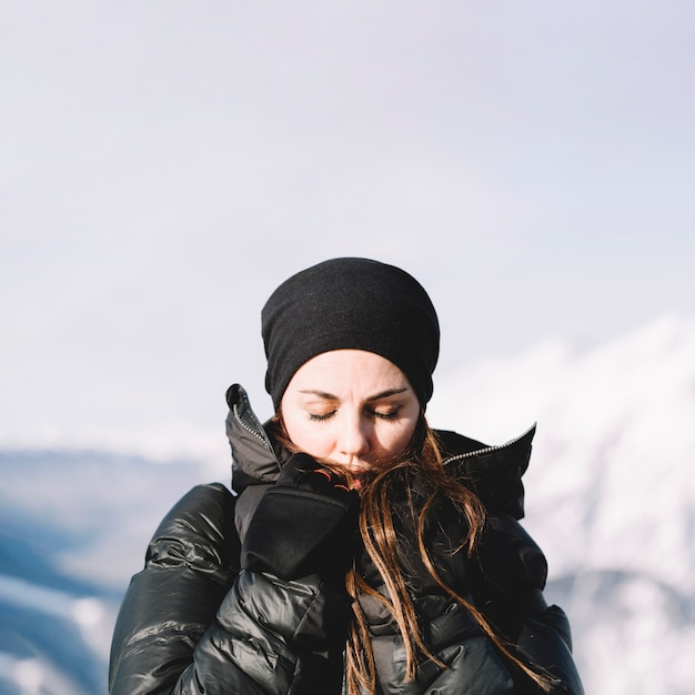 Free photo woman warming hands with closed eyes