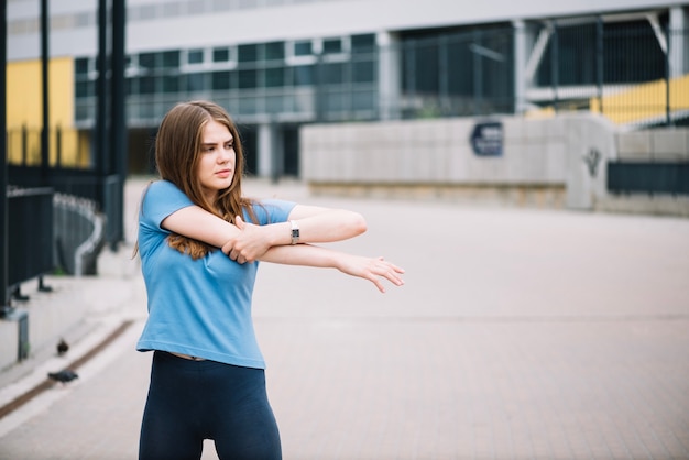 Free photo woman warming up on street