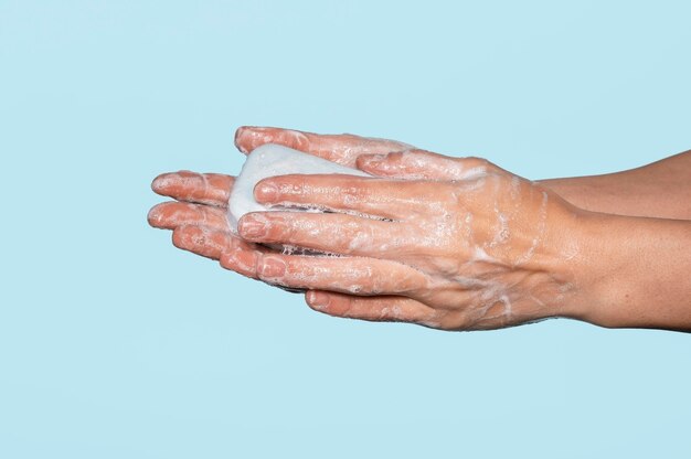 Woman washing hands isolated on blue