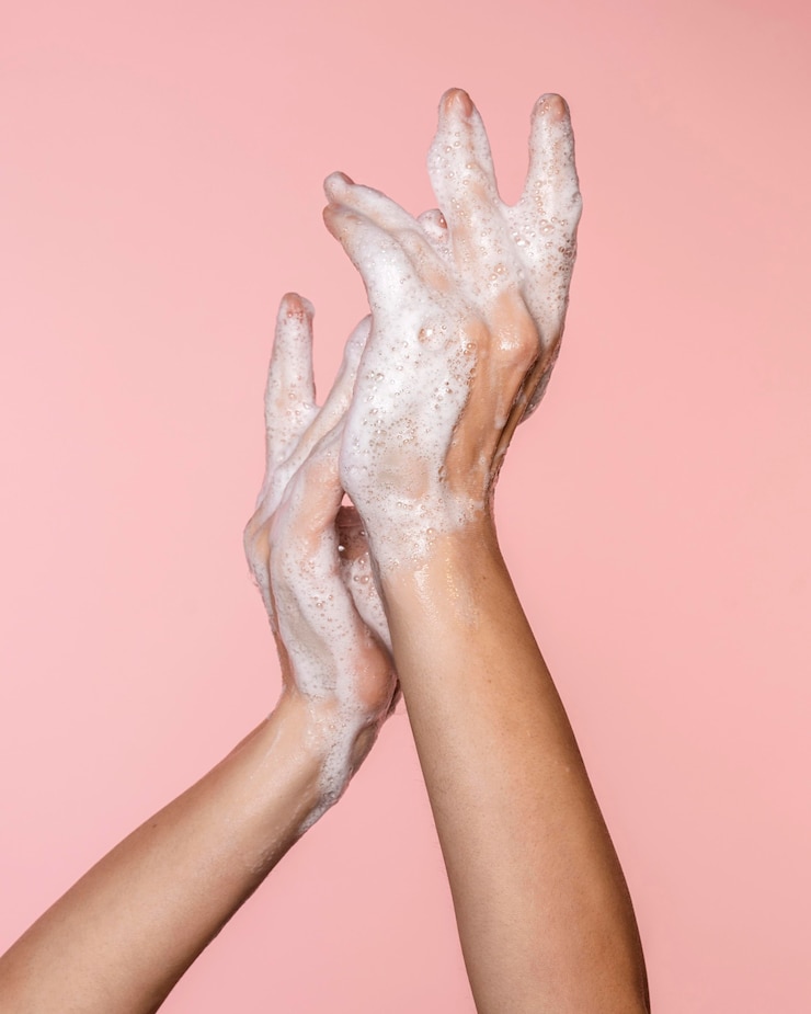 Free Photo woman washing hands isolated on pink