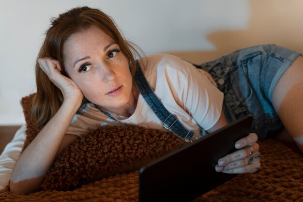 Woman watching a movie on streaming service at home